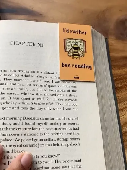Another look at the "I'd rather bee reading" bookmark, keeping its place in a novel.