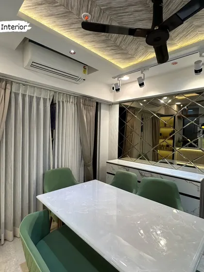A close-up of the dining area, showing the beveled mirror paneling and track lighting.