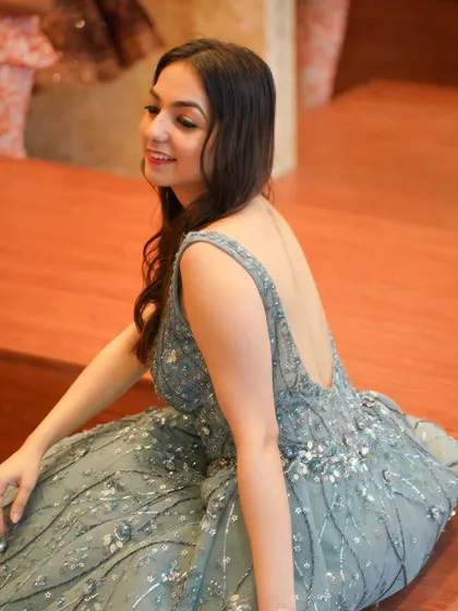 A candid shot capturing the elegance and grace of the backless gown. Perfect inspiration for anyone looking for a unique wedding guest outfit.