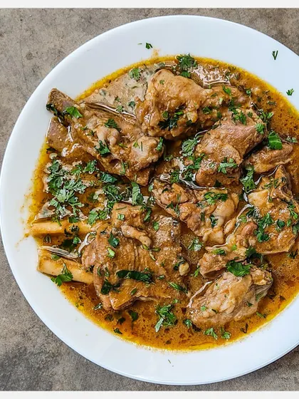 A serving of my rich Bannur Mutton Saaru, with tender meat falling off the bone.