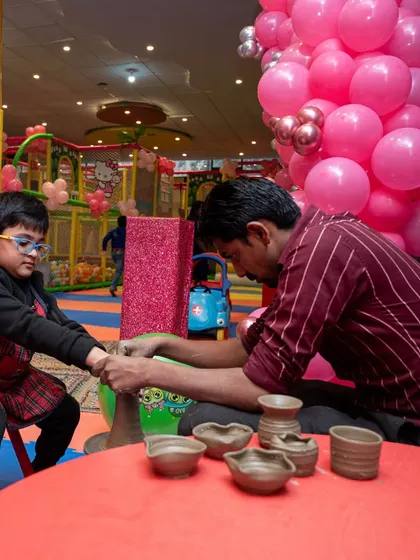 Even at a Barbie party, there's room for hands-on creativity. Here, a young guest gets to try his hand at pottery, one of the many diverse activities I can arrange.