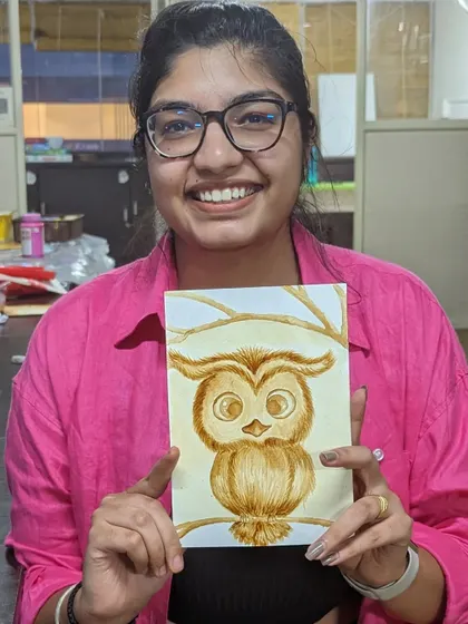 A participant with her adorable coffee painting of an owl.