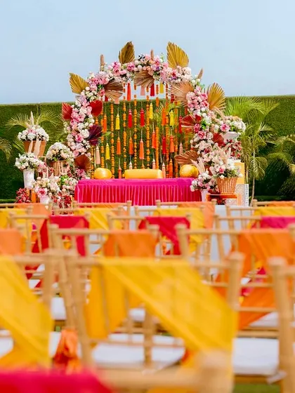 The complete Mehendi setup, with colorful chair ties for guests that match the overall decor theme, ensuring a cohesive and visually appealing event.