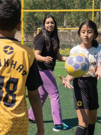 A mother participating in a ball game with the kids at the Rush Festival. We love seeing our parents get involved and share in the fun.