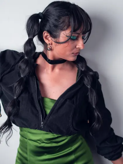 A side profile showing the complete 'Art in Motion' look. The combination of the green dress, black hoodie, and unique hairstyle demonstrates my creative styling capabilities.