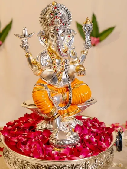 Where there is Ganpati, there is wisdom and prosperity. This beautiful silver Ganesha idol, adorned with colorful details, is a beacon of positive energy and a perfect addition to your sacred space.