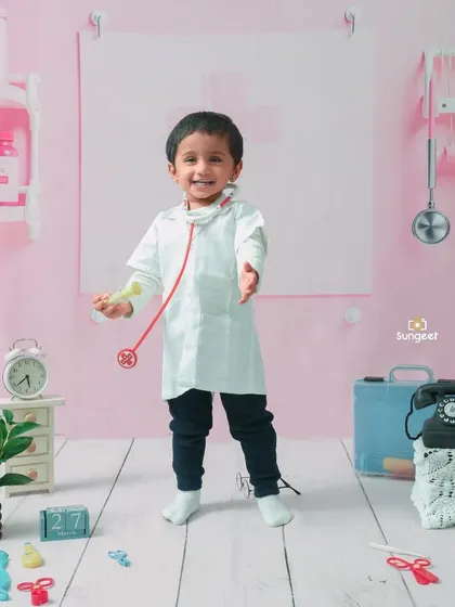A happy and welcoming little doctor. The joy on his face shows how much fun toddlers have when they get to play dress-up and explore our creative worlds.