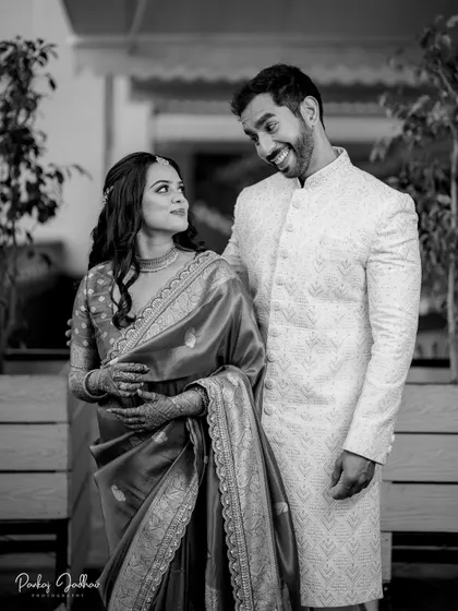 A playful, candid interaction between the couple, captured in timeless black and white.