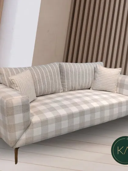 This sofa features a charming mix of plaid and striped patterns in a neutral color palette. It’s an example of how we can combine different textiles to create a piece that is both cozy and visually interesting.