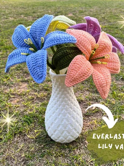 An everlasting lily vase. This arrangement of colorful crochet lilies in a white vase is a perfect, elegant centerpiece for any room.