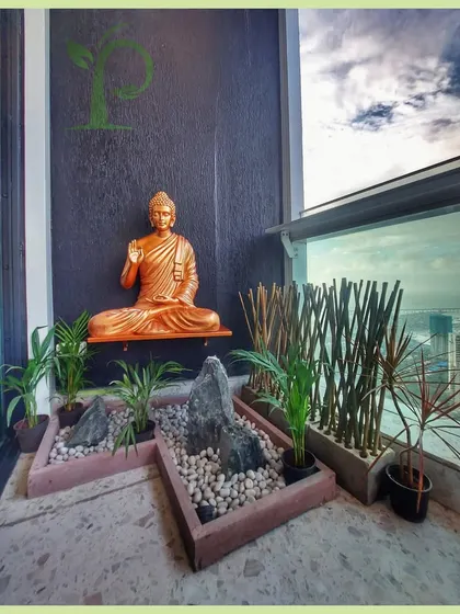 I designed this balcony as a personal Zen garden, a space for peace and meditation high above the city. The design integrates a calming Buddha statue, minimalist rock arrangements, and carefully selected plants like Areca palms to create a tranquil atmosphere.