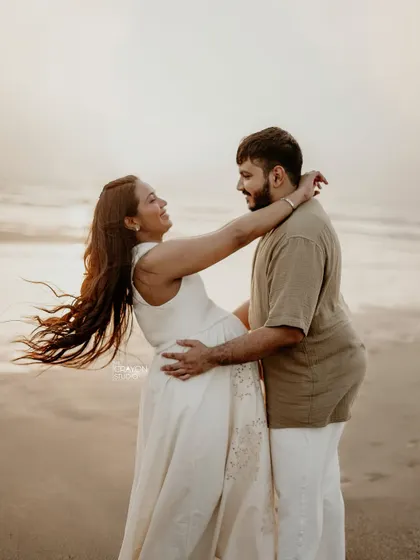 An outdoor maternity shoot on the beach is all about capturing pure, uninhibited joy. I love these moments of laughter and connection, where you can almost feel the sea breeze and the warmth of their love.