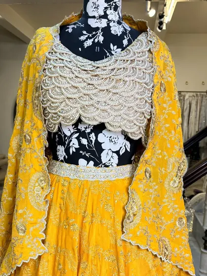 The full view of the haldi lehenga, showcasing the flowy skirt and the statement blouse.