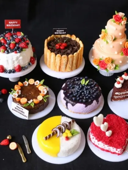 A beautiful collection of various miniature cakes, perfect for celebrating any occasion.