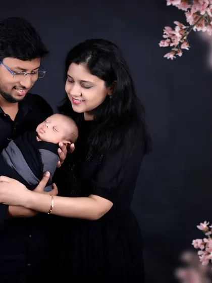 A beautifully composed family portrait with a touch of nature. The cherry blossom overlay adds a delicate and artistic element to the photo.