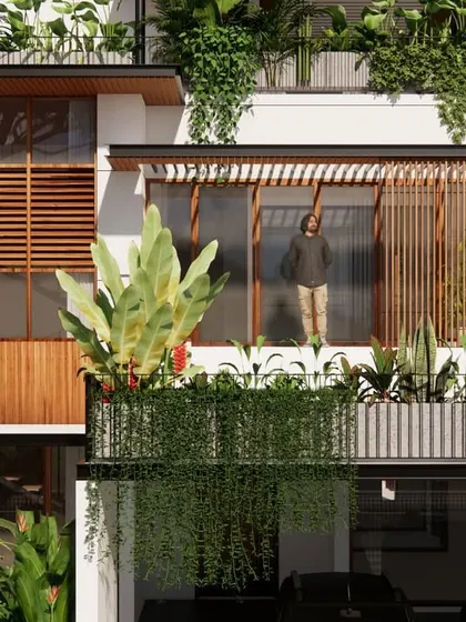 A detail of the Still House facade, where cascading greenery and wooden screens soften the structure. This approach blurs the line between the built and the unbuilt, making the home feel like a natural extension of its tropical setting.