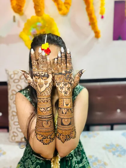 A lovely bridal back-hand design done by my talented team artist, Kinjal. The twin peacocks are just perfect.