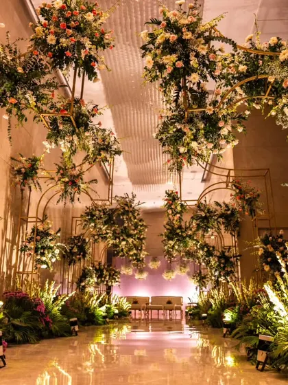I designed this breathtaking floral walkway to lead guests to the main seating area. The golden arches adorned with flowers and greenery created an immersive and luxurious entrance experience.
