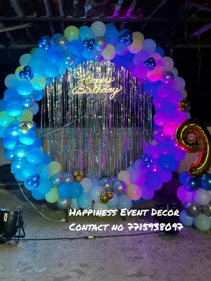 This balloon ring was set up on a terrace for a 9th birthday party. The blue balloons are lit from within, and the silver shimmer curtain in the center adds a touch of sparkle.