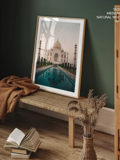 Capture the timeless beauty of the Taj Mahal with this stunning photographic print. The serene and majestic image, presented in a natural wood frame with glass, brings a piece of India's iconic architecture into your home.