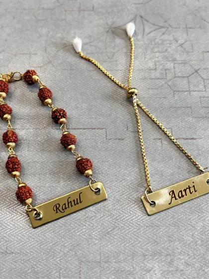 A perfect Rakhi pair for your brother and sister-in-law (Bhaiya-Bhabhi). We have a Rudraksha rakhi for him and a matching Lumba for her, both with personalized nameplates.