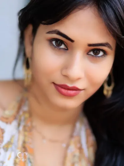 An intimate and captivating close-up. The focus is entirely on her expressive eyes and gentle smile.