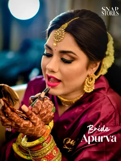 A candid shot of the bride doing a final touch-up on her makeup. We document the behind-the-scenes moments of getting ready for the big day.