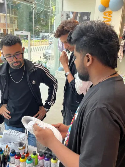 Collaboration is key. Here, we're discussing design ideas directly with customers at our live art station. This personal interaction ensures every person walks away with a custom piece they truly love.