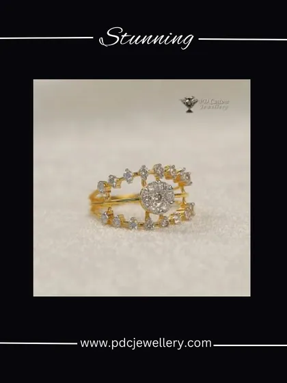 A stunning and unique diamond ring design in 18kt hallmarked gold. The open-work band is studded with diamonds, leading to a beautiful central cluster.