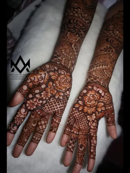 A full view of the engagement mehendi, featuring beautiful rose motifs and net patterns.