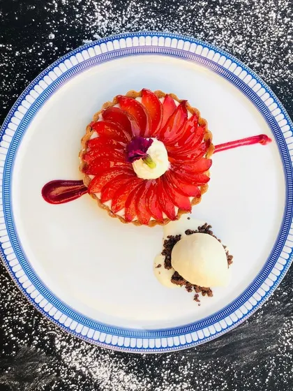 Dessert photography needs to look delicious. This top-down shot of a fruit tart uses a dark, contrasting background and a sprinkle of powdered sugar to make the vibrant colors of the fruit pop, creating a piece of edible art.