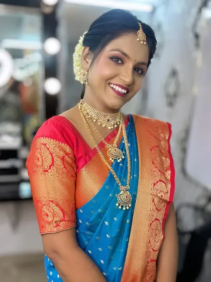 The final look from the demonstration, a happy model with glowing makeup and traditional attire.