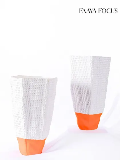 We love to play with unexpected color. These white waffle-textured vases get a surprising pop of bright orange at the base, adding a playful and contemporary twist to a classic form.