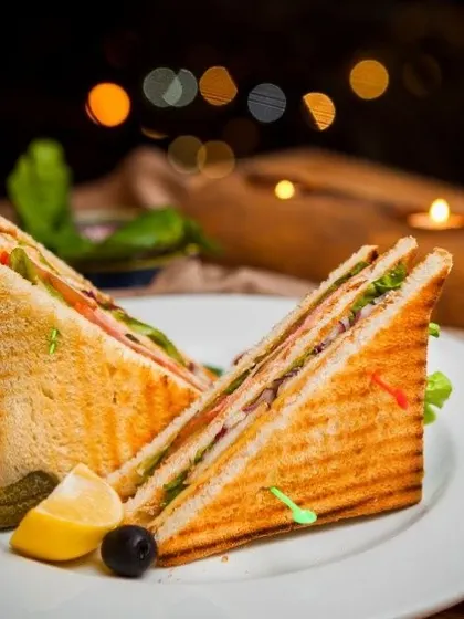 Our classic club sandwich, perfectly grilled and layered with fresh lettuce, vegetables, and fillings. It's an ideal choice for corporate lunches, high-tea events, or as a light party snack.