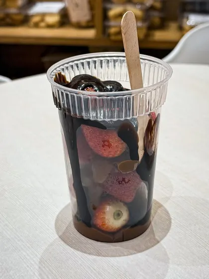 A cup of fresh strawberries loaded with rich, melted chocolate. A simple, decadent treat from our seasonal menu.