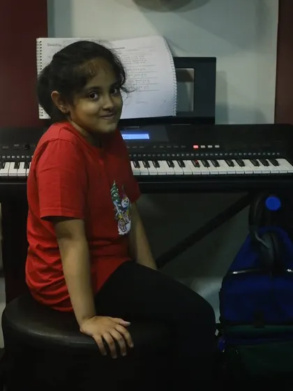 A student sitting at her keyboard, ready for her lesson to begin. We provide a welcoming environment for students of all ages.