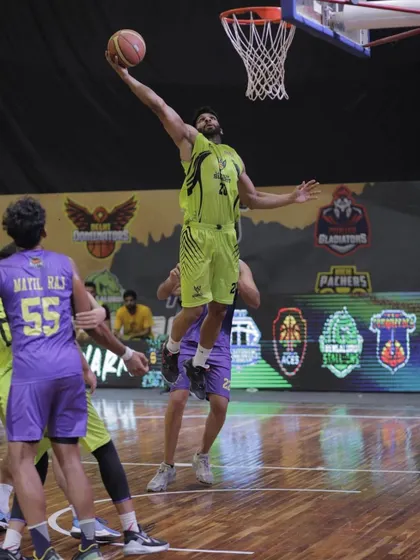 An athletic layup in traffic during a professional game. This is the result of countless hours spent on finishing drills.