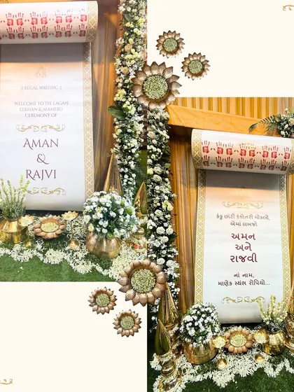 A personalized welcome scroll for the Kankotri Lekhan ceremony of Aman and Rajvi. This custom detail, surrounded by brass props and florals, adds a unique and personal touch to the event.