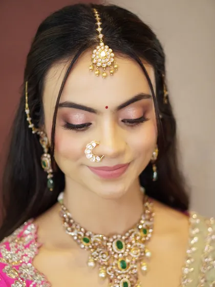 A close-up of Likitha's soft and shimmery eye makeup. The delicate pink and gold tones are perfect for enhancing her features without being overpowering.