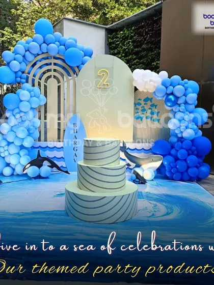 "Dive into a sea of celebrations with our themed party products." This ocean themed second birthday setup, with its wave-like floor and blue balloon arches, perfectly captures this motto.