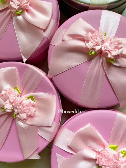 A close-up of the delicate, handcrafted ribbon bows on our Women's Day gift tins. We believe presentation is key.