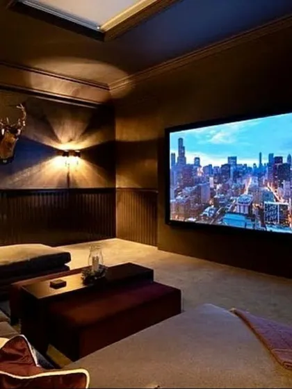 We transformed this den into a cozy and inviting media room. The large screen is the centerpiece, complemented by a comfortable sectional sofa and warm, indirect lighting. This design proves that a compelling cinematic experience can be achieved in a relaxed, multi-purpose environment.