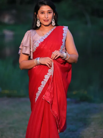 The simplicity of this red saree is its strength, allowing you to shine.