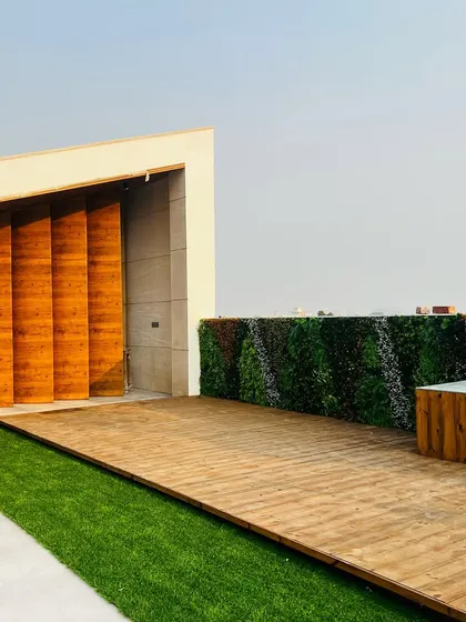 The space begins to take shape with a vertical garden wall and a wooden storage bench, adding both greenery and functionality.