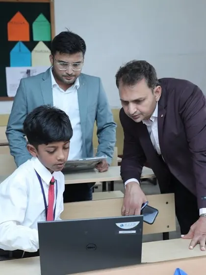 Our founder, Dhananjay Singh, leans in to get a closer look at a student's coding project during the RW2024 competition. We believe in nurturing talent through direct interaction and encouragement.
