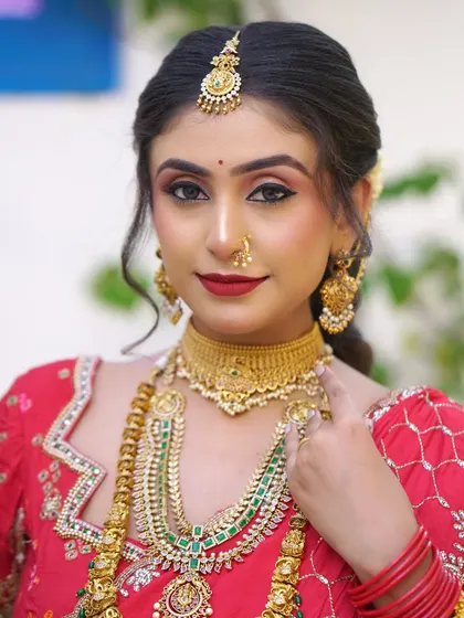 A close-up portrait that captures a classic, confident expression. The red lip and defined eyes are hallmarks of a timeless bridal look.