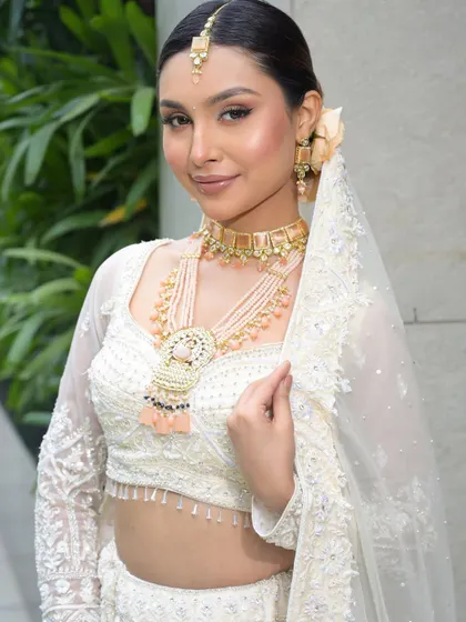 The bride with her veil, looking radiant and serene. The makeup is designed to look flawless from every angle and to photograph beautifully.