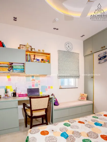 This teen's room features a well-organized study desk with overhead storage and a pin-up board, creating a perfect zone for homework and creativity.