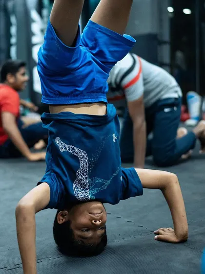 It's not all serious. We encourage playful movement to build body awareness and strength, like this young warrior mastering a headstand.