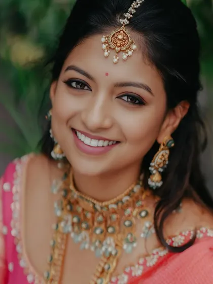 A close-up, smiling portrait, her joy infectious and her makeup flawless.